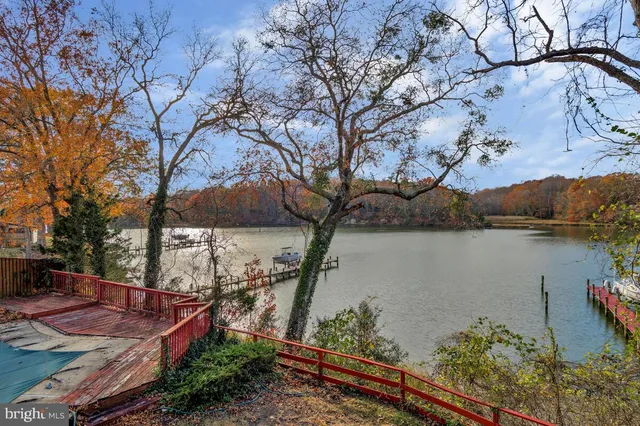 a view of residential houses with outdoor space and lake view