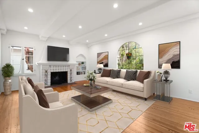 a living room with furniture fireplace and a flat screen tv