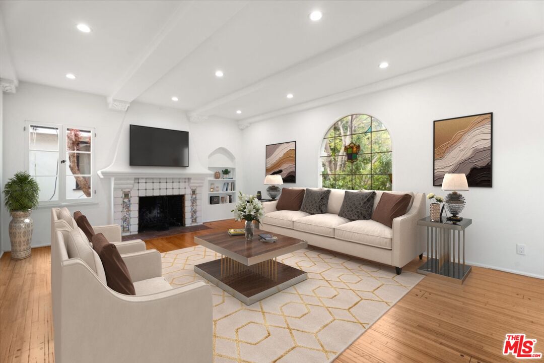 a living room with furniture fireplace and a flat screen tv
