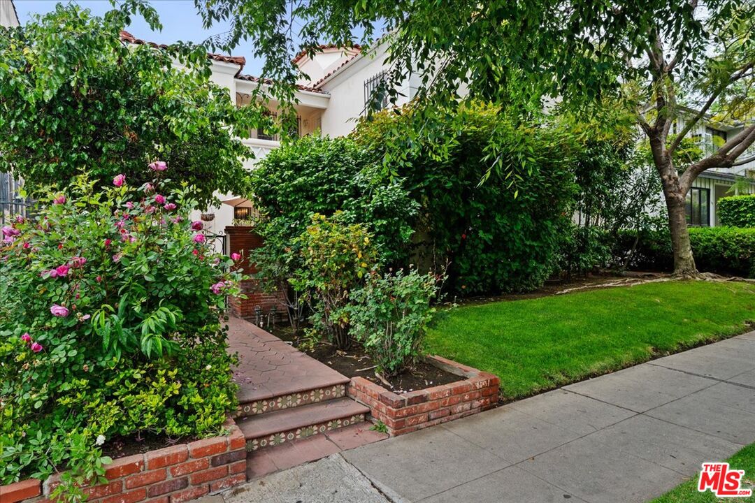 205 South Reeves Drive Beverly Hills, CA 90212 - Photo 12 of 13 a view of backyard with outdoor seating and green space
