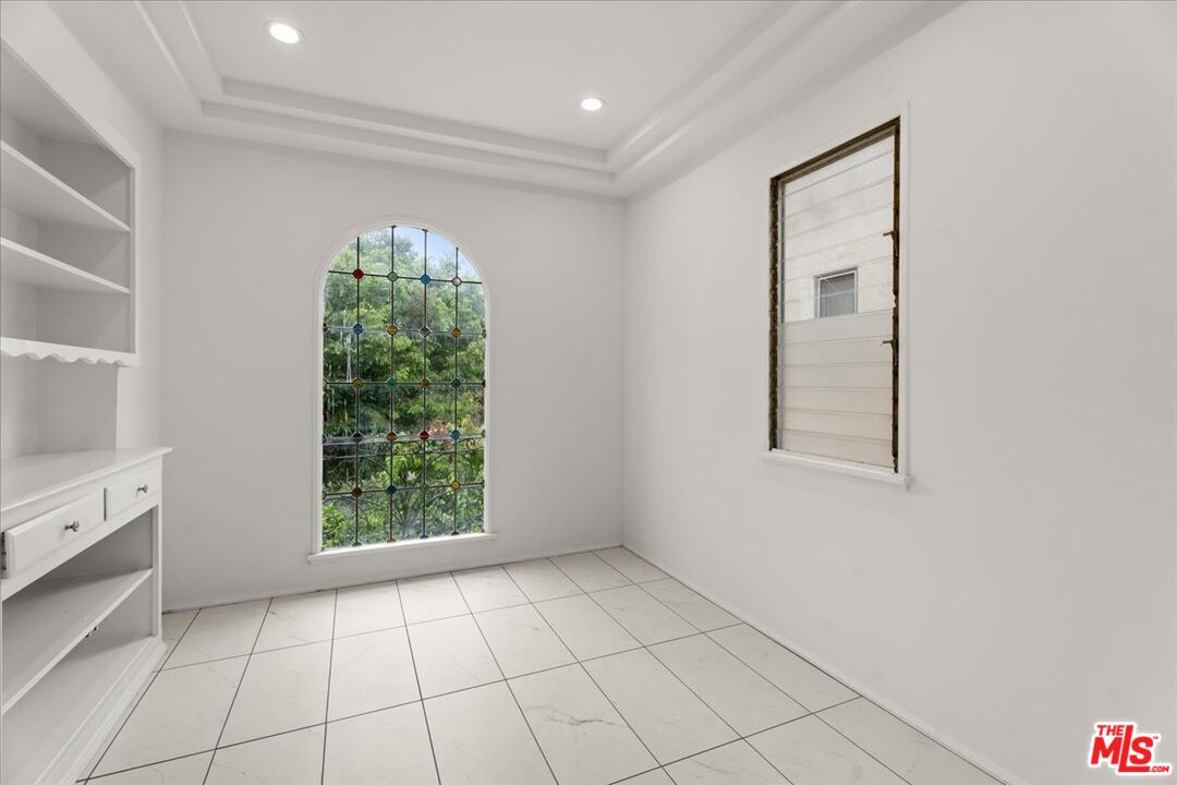205 South Reeves Drive Beverly Hills, CA 90212 - Photo 5 of 13 an empty room with windows
