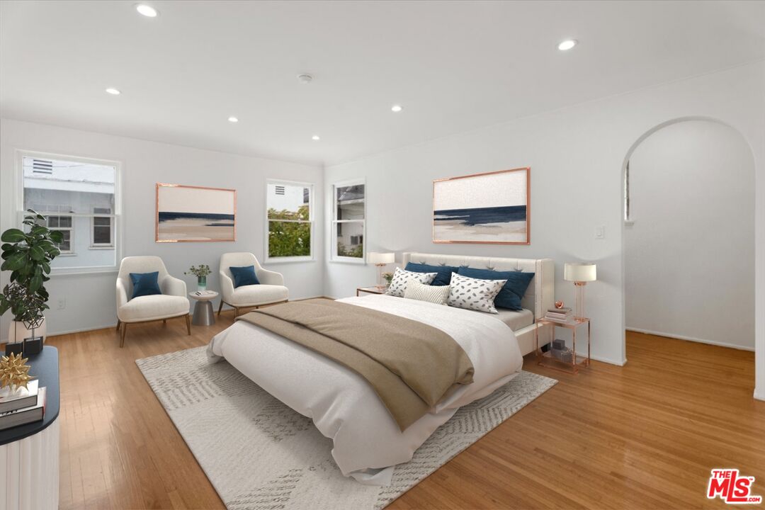 205 South Reeves Drive Beverly Hills, CA 90212 - Photo 6 of 13 a spacious bedroom with a large bed and windows