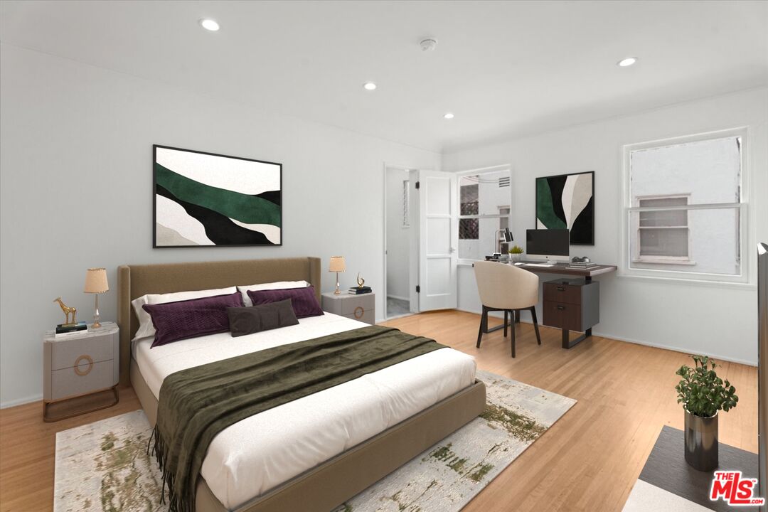 205 South Reeves Drive Beverly Hills, CA 90212 - Photo 8 of 13 a bedroom with a bed a mirror and furniture