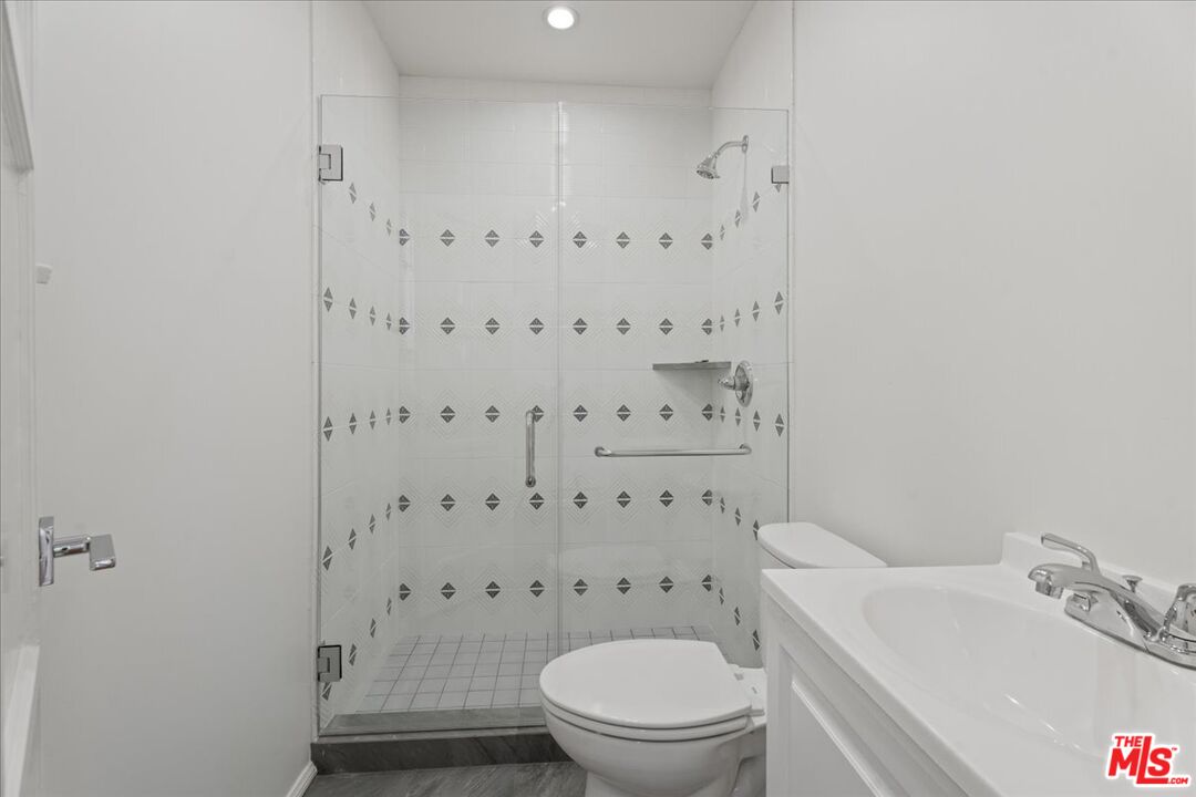 205 South Reeves Drive Beverly Hills, CA 90212 - Photo 9 of 13 a bathroom with a toilet and a shower