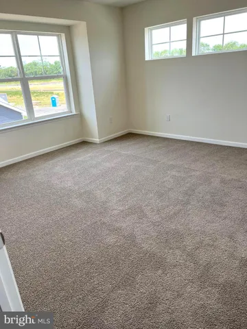 a spacious bathroom with a toilet a sink and a window