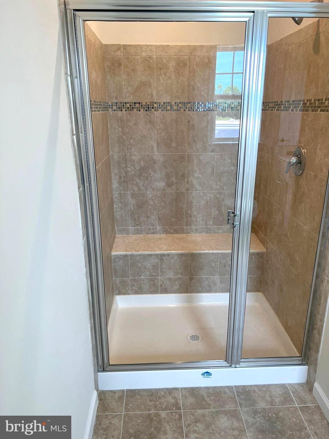 20141 Riesling Lane, Unit 309 Lewes, DE 19958 - Photo 6 of 12 a bathroom with a glass shower door