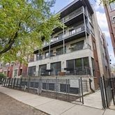 a view of a large building with a tree