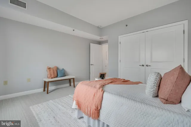 a bedroom with a bed and a table