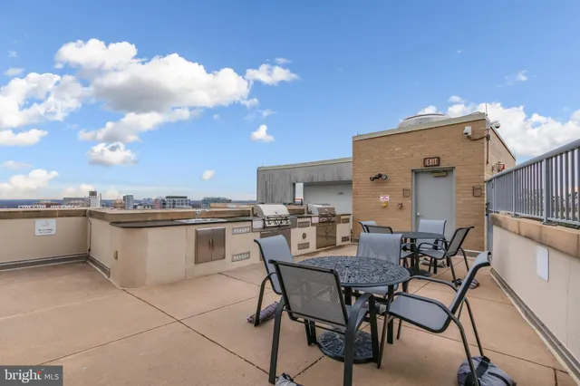 a view of a patio with dining table and chairs with wooden floor