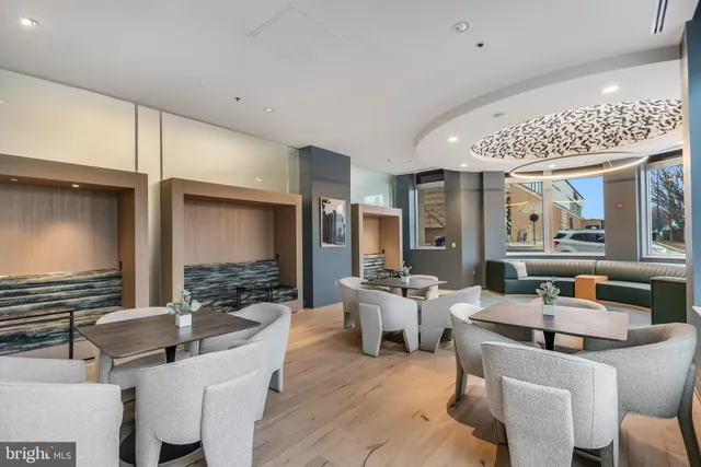 a living room with fireplace furniture and a large window