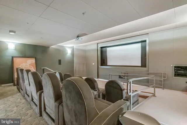 a room with chairs projector and screen