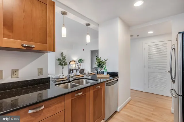 a kitchen with stainless steel appliances a sink and a refrigerator