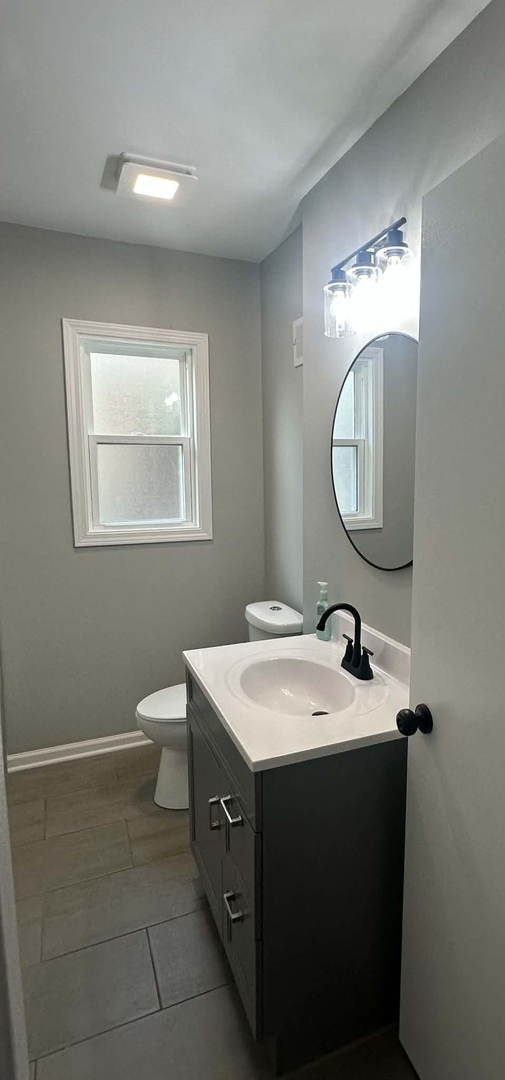 513 Cookane Avenue Elgin, IL 60120 - Photo 14 of 26 a bathroom with a sink and a mirror