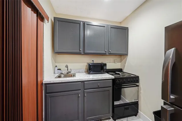 a kitchen with a sink and a refrigerator