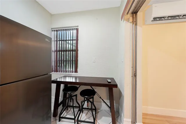 a view of a room that has a wooden floor and entryway