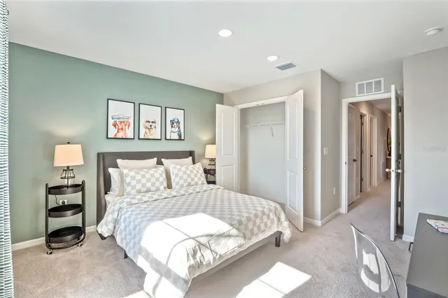 a bedroom with a large bed and a chandelier