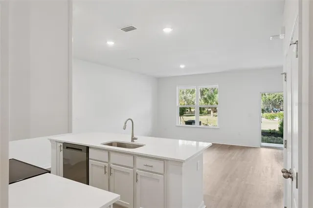 a kitchen with a sink and large window