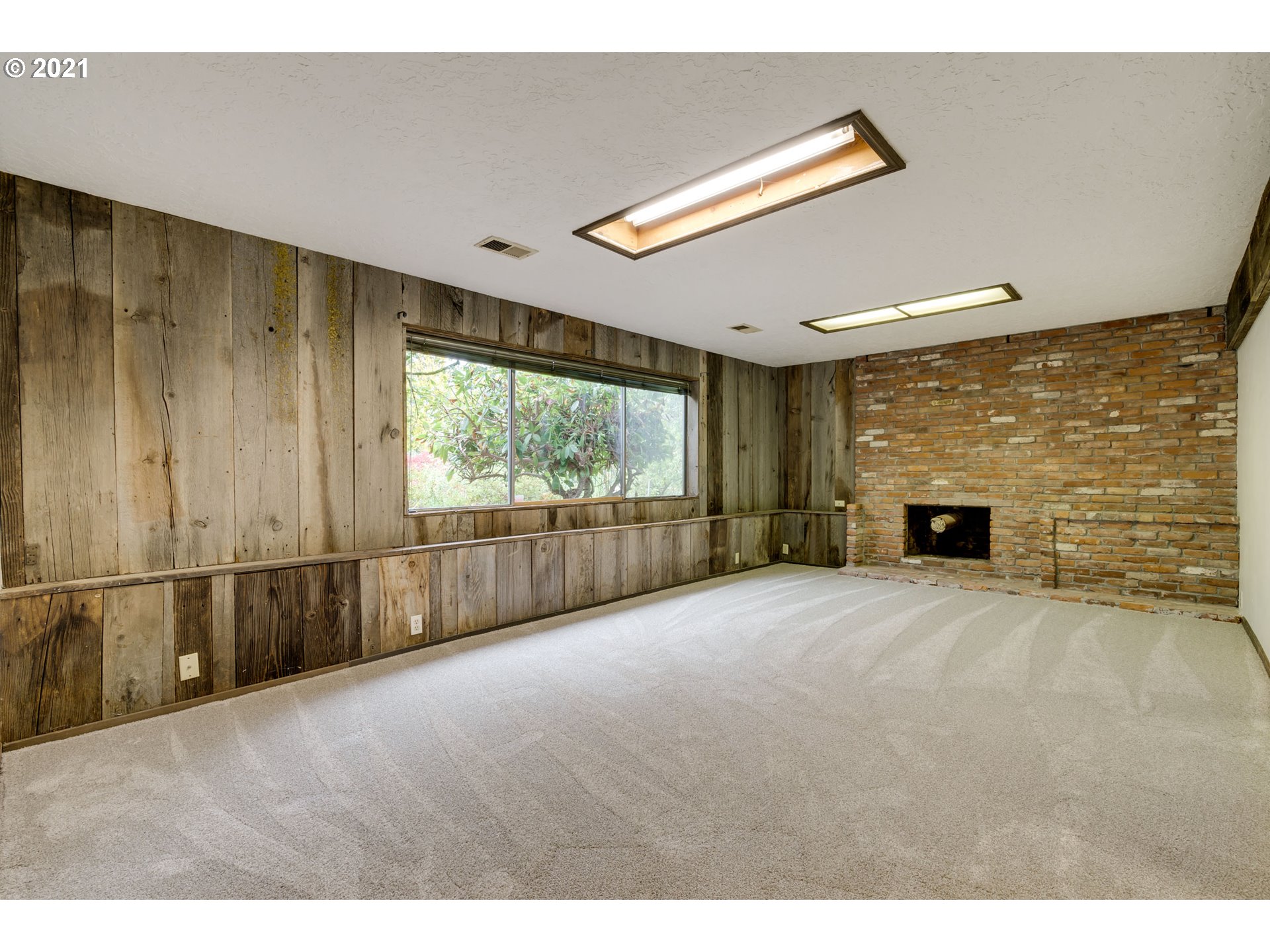 17201 Southeast Tong Road Damascus, OR 97089 - Photo 14 of 21 a view of an empty room with a fireplace and a window
