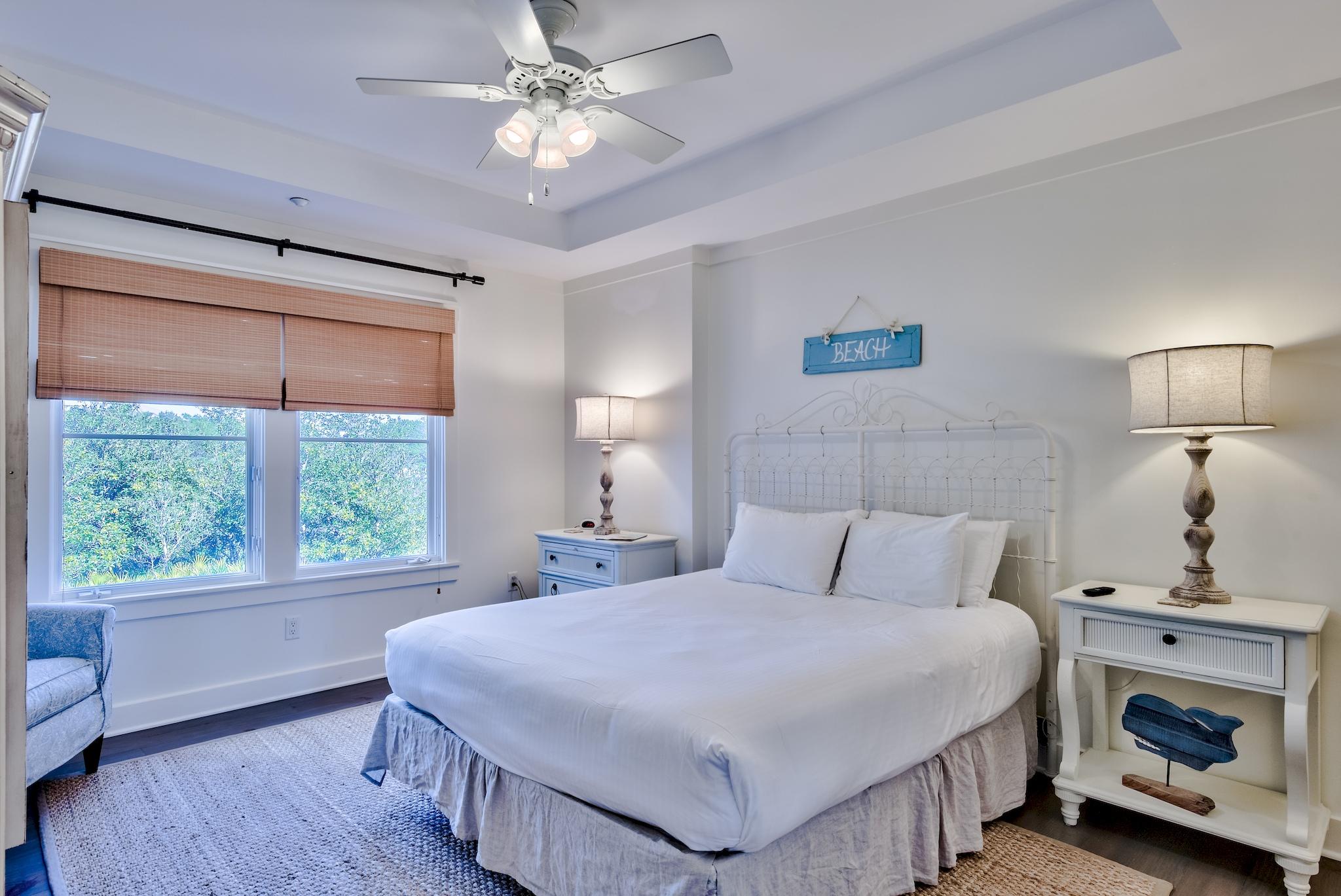 337 Bridge Lane, Unit B102 Watersound, FL 32461 - Photo 17 of 41 a bedroom with a large bed and a chandelier