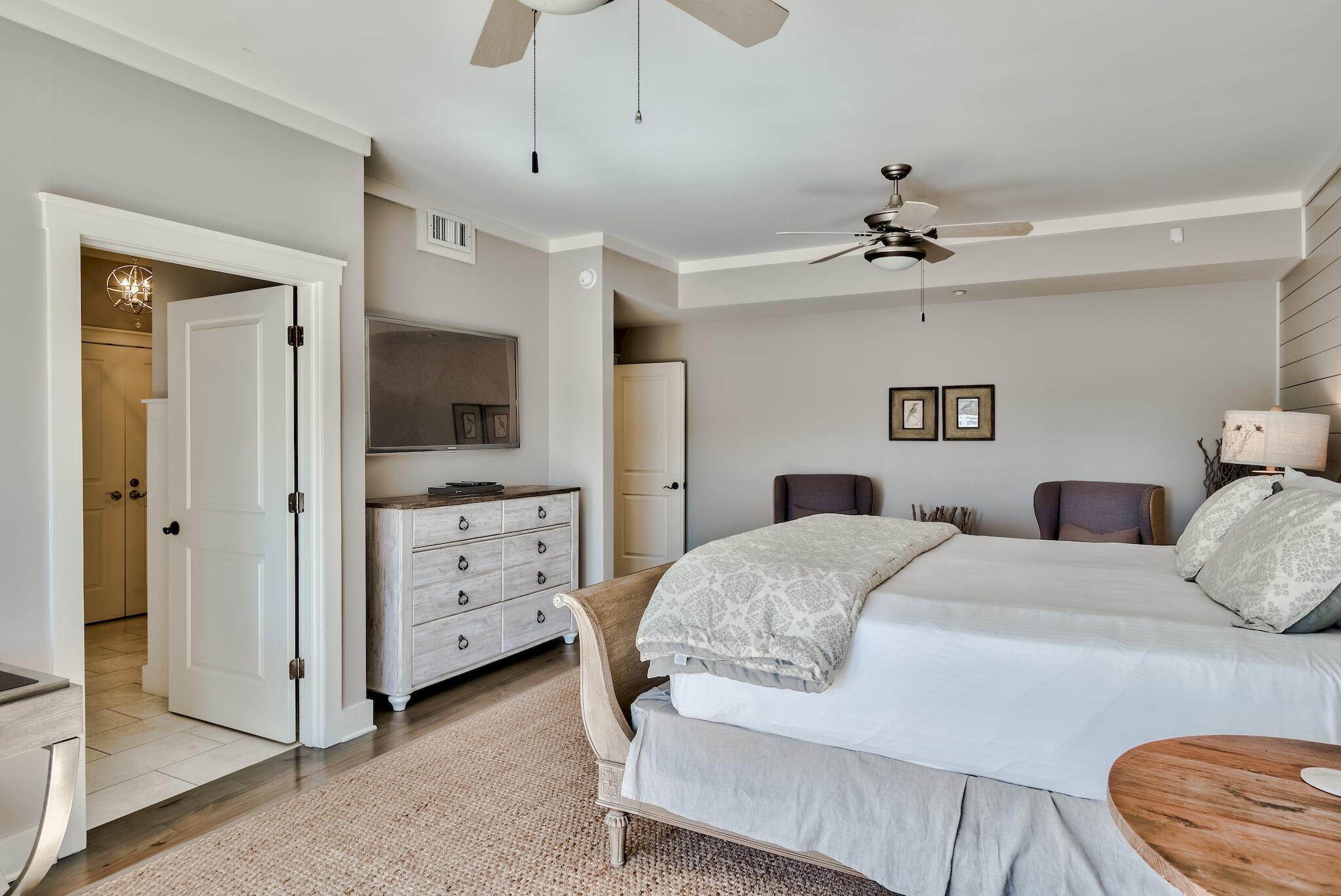 337 Bridge Lane, Unit B102 Watersound, FL 32461 - Photo 30 of 41 a bedroom with a bed and a dresser