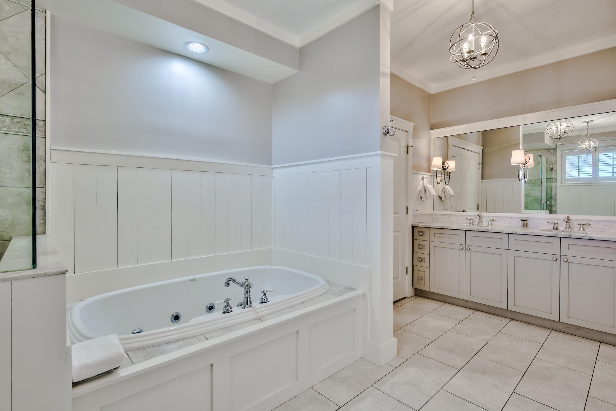 337 Bridge Lane, Unit B102 Watersound, FL 32461 - Photo 33 of 41 a bathroom with a bathtub a sink and a mirror