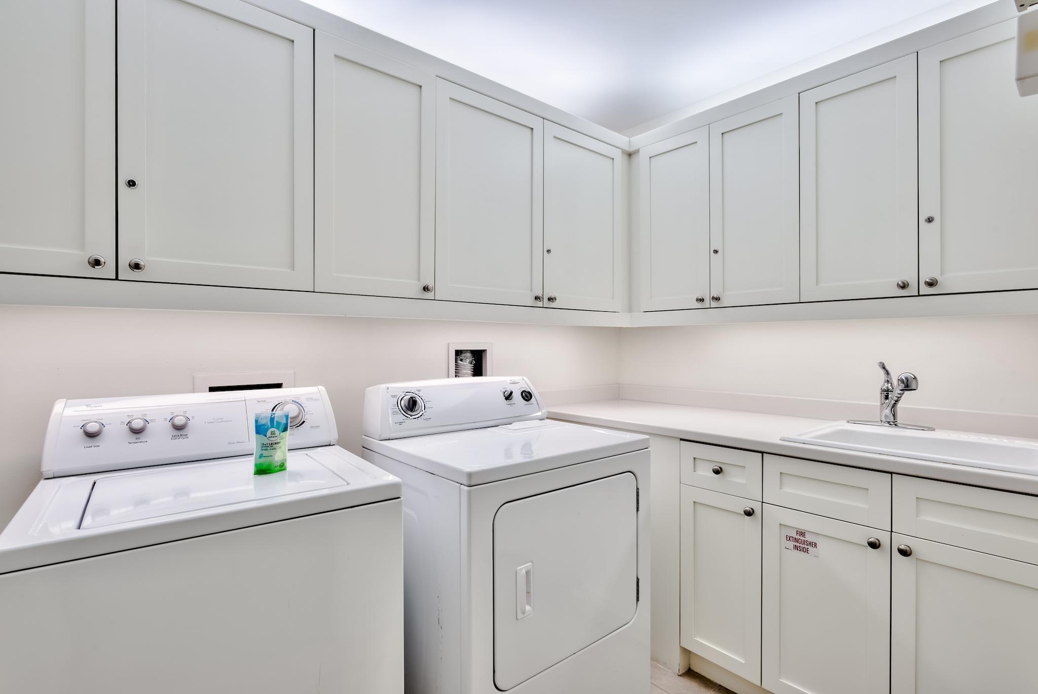 337 Bridge Lane, Unit B102 Watersound, FL 32461 - Photo 34 of 41 a utility room with stainless steel appliances white cabinets sink and stove