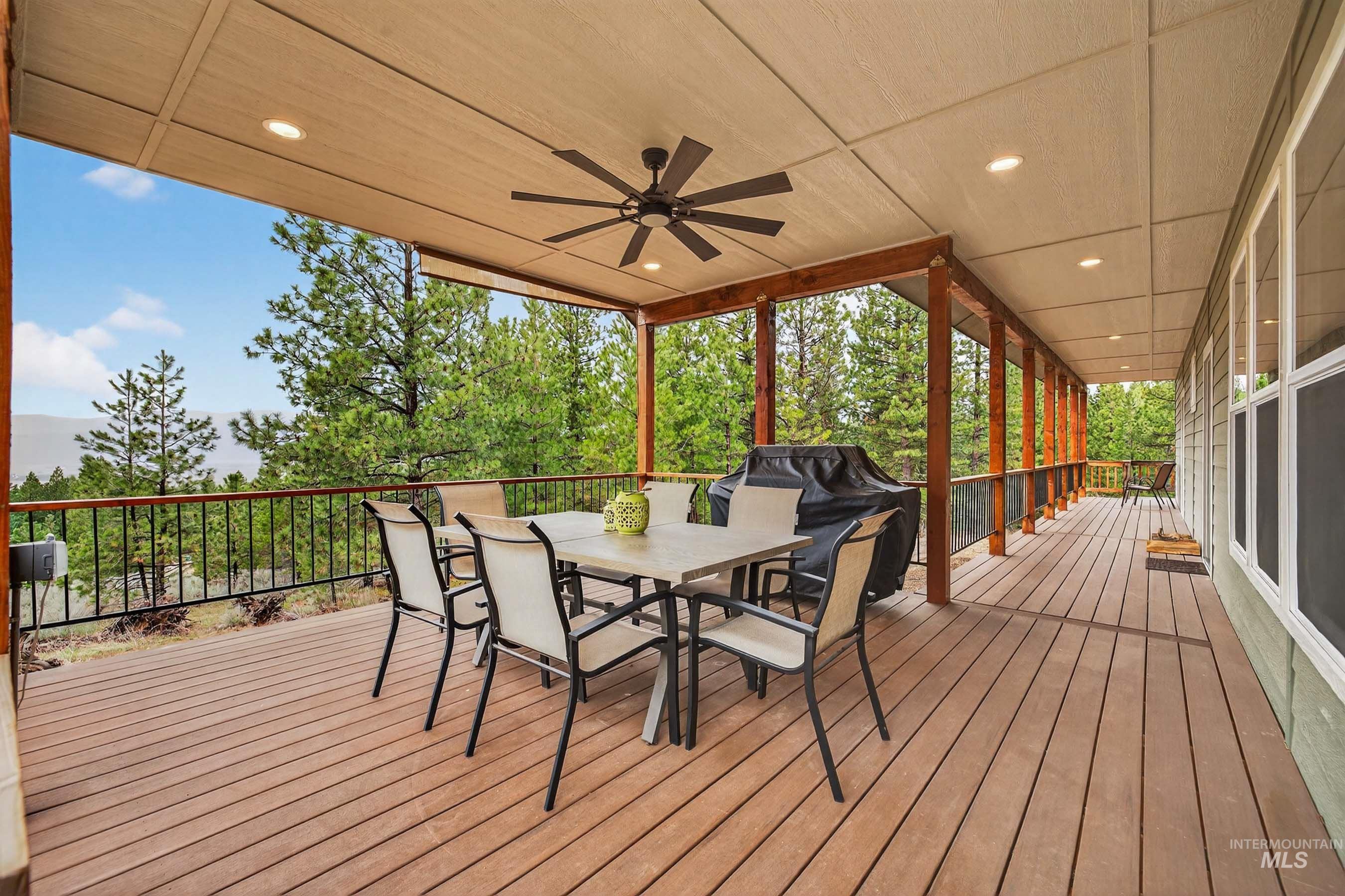 10191 Timberrim Drive Cascade, ID 83611 - Photo 30 of 44 Deck featuring a ceiling fan, outdoor dining area, and grilling area