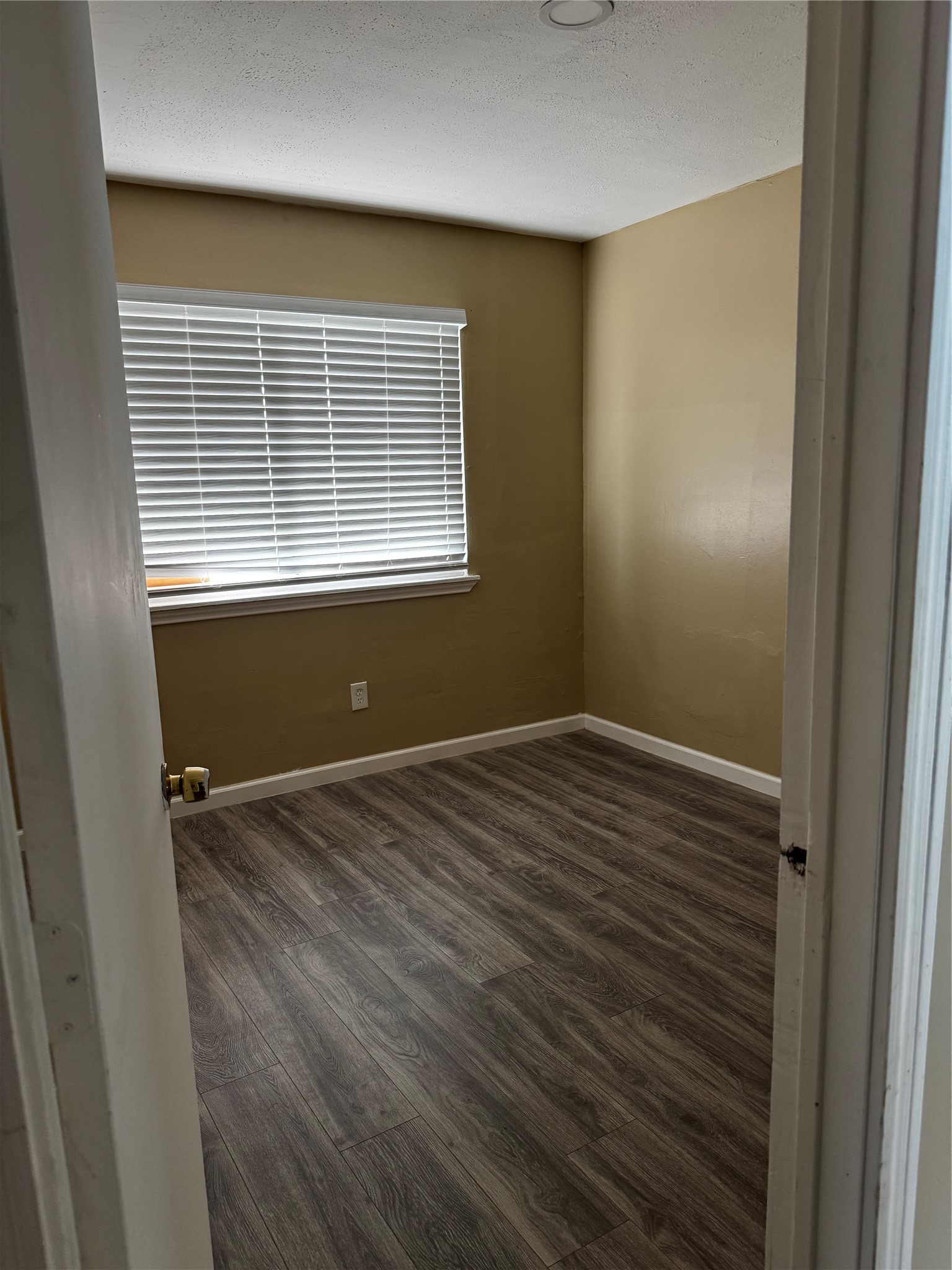 4515 7th Street Bacliff, TX 77518 - Photo 13 of 15 a view of empty room with wooden floor and fan