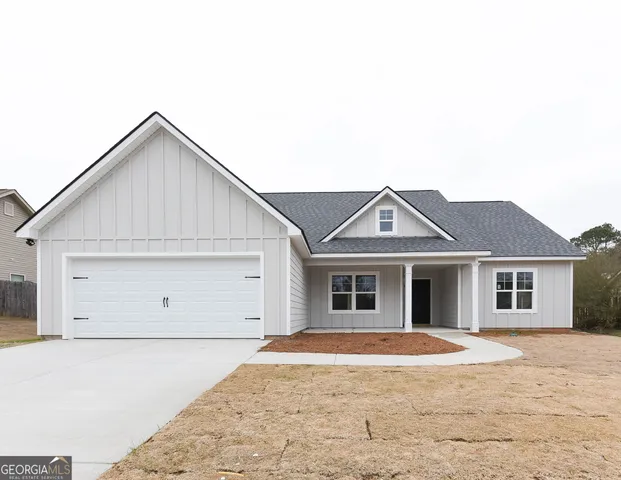 a view of a house with a backyard