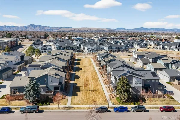 an aerial view of residential houses with city view
