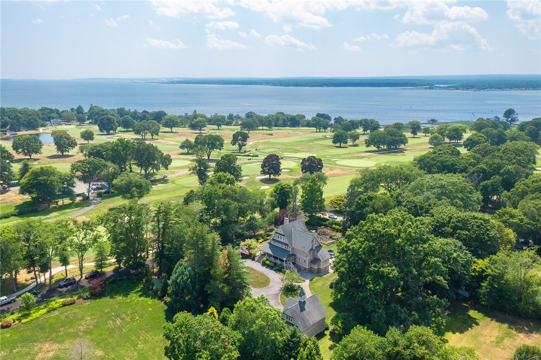 Front porch overlooks the 14th hole at Warwick Country Club with views of Greenwich/Narragansett Bay beyond.