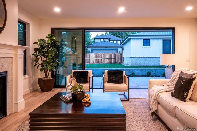 a living room with furniture fireplace and palm tree