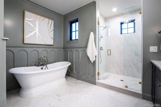 a bathroom with a sink and mirror with bathtub