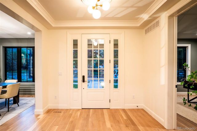 a view of a room with wooden floor and furniture