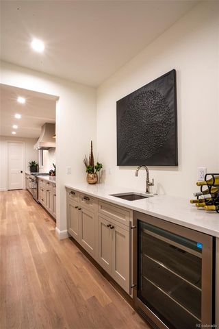 a view of living room with stainless steel appliances kitchen island sink and cabinets