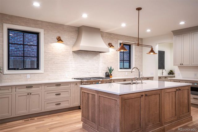 a kitchen with a sink stove and cabinets