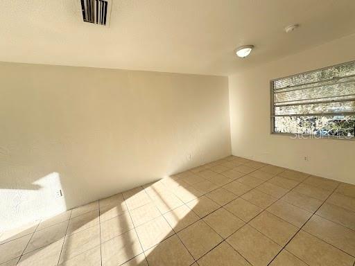 1221 Kennedy Road, Unit 48 Daytona Beach, FL 32117 - Photo 6 of 12 a view of an empty room and window
