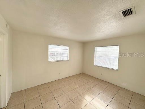 1221 Kennedy Road, Unit 48 Daytona Beach, FL 32117 - Photo 8 of 12 an empty room with windows