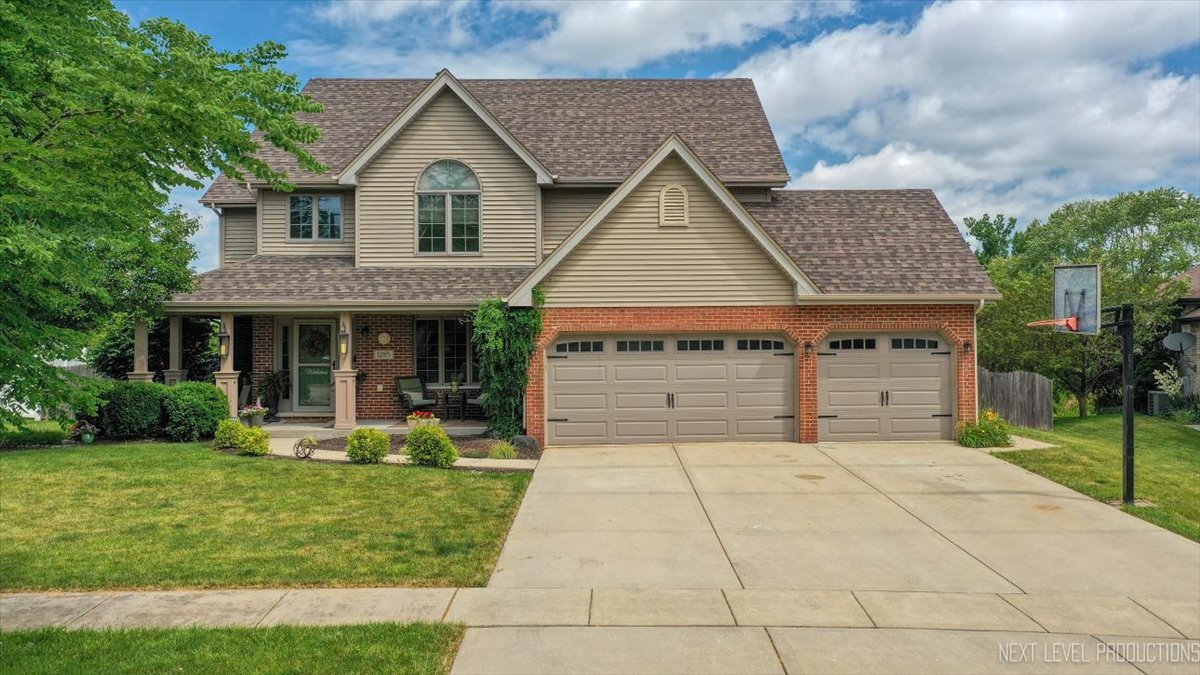 1285 O'Connell Circle New Lenox, IL 60451 - Photo 1 of 42 a front view of a house with garden