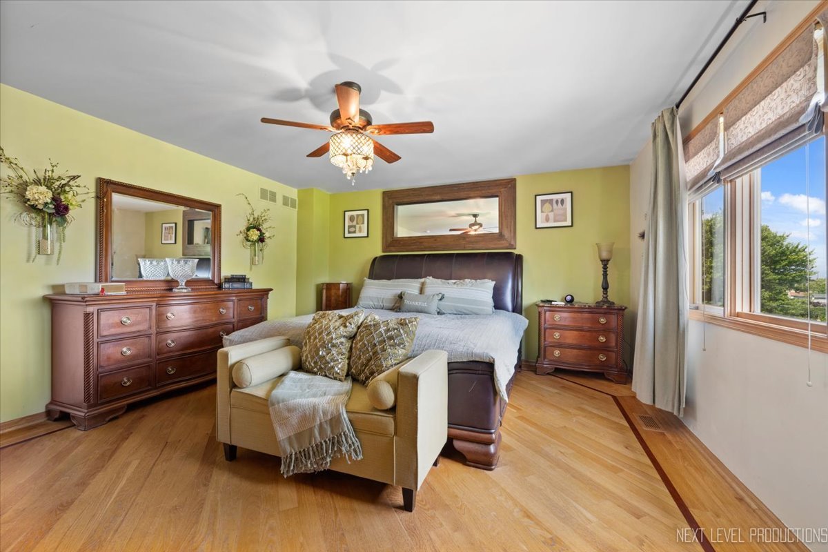 1285 O'Connell Circle New Lenox, IL 60451 - Photo 19 of 42 a bedroom with a bed and wooden floor