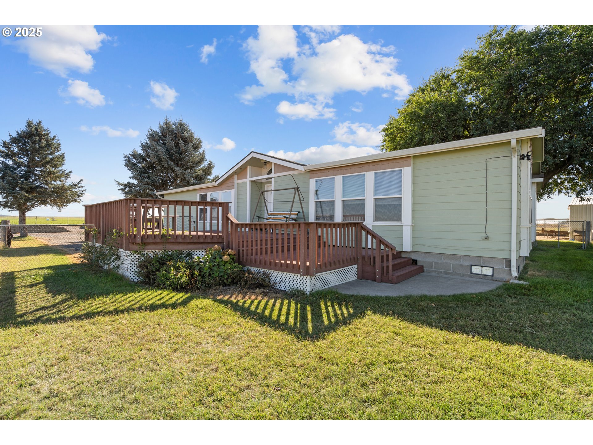 a view of a house with a yard and deck