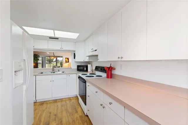a kitchen with a sink a stove and cabinets