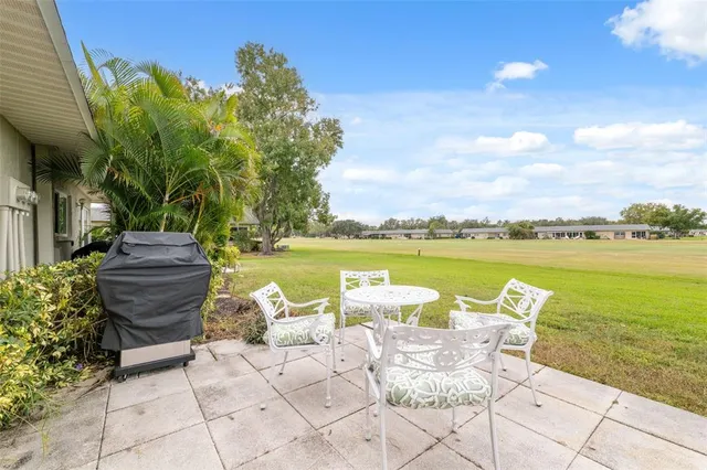 a view of a patio with table and chairs and potted plants