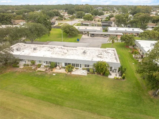 an aerial view of residential houses with outdoor space and swimming pool