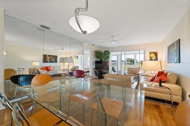 a living room with furniture kitchen view and a large window