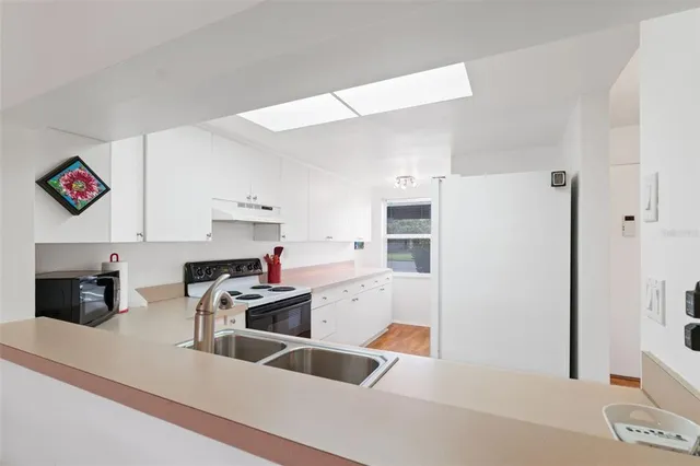 a kitchen with a refrigerator and a sink