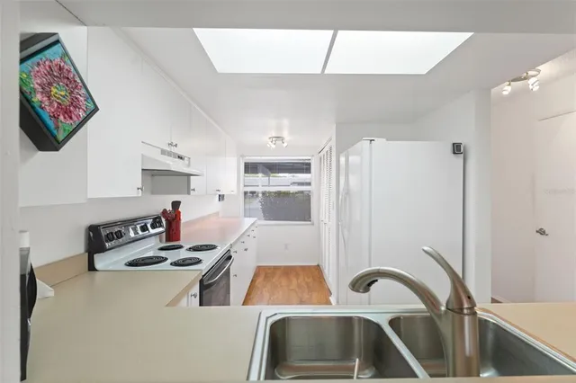 a kitchen with a refrigerator and a sink