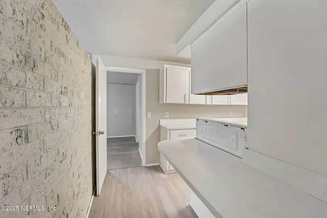 a view of a bedroom with wooden floor