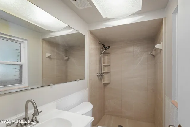 a bathroom with a sink and shower