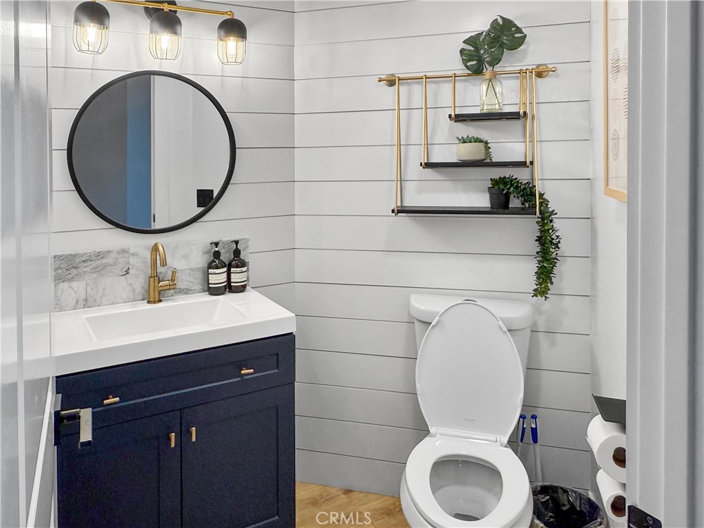 16955 Lake Knoll Parkway Riverside, CA 92503 - Photo 34 of 42 a bathroom with a toilet mirror and sink